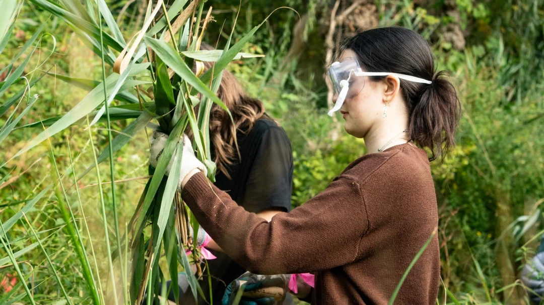 Lady with googles holding a plant