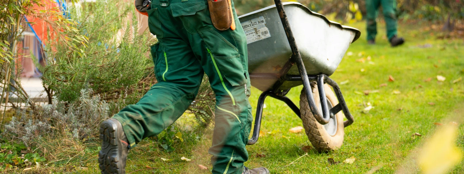 Man pushing wheel barrow